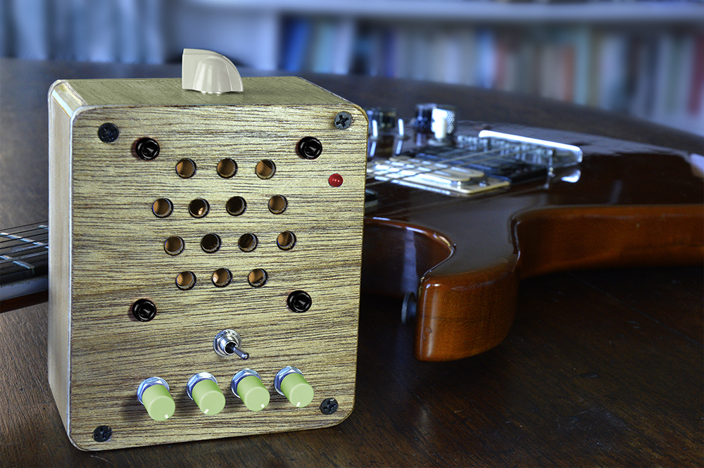 Moon Canoe Brak ver3 portable usb rechargeable practise amp with olive green knobs and overdrive switch next to electric guitar